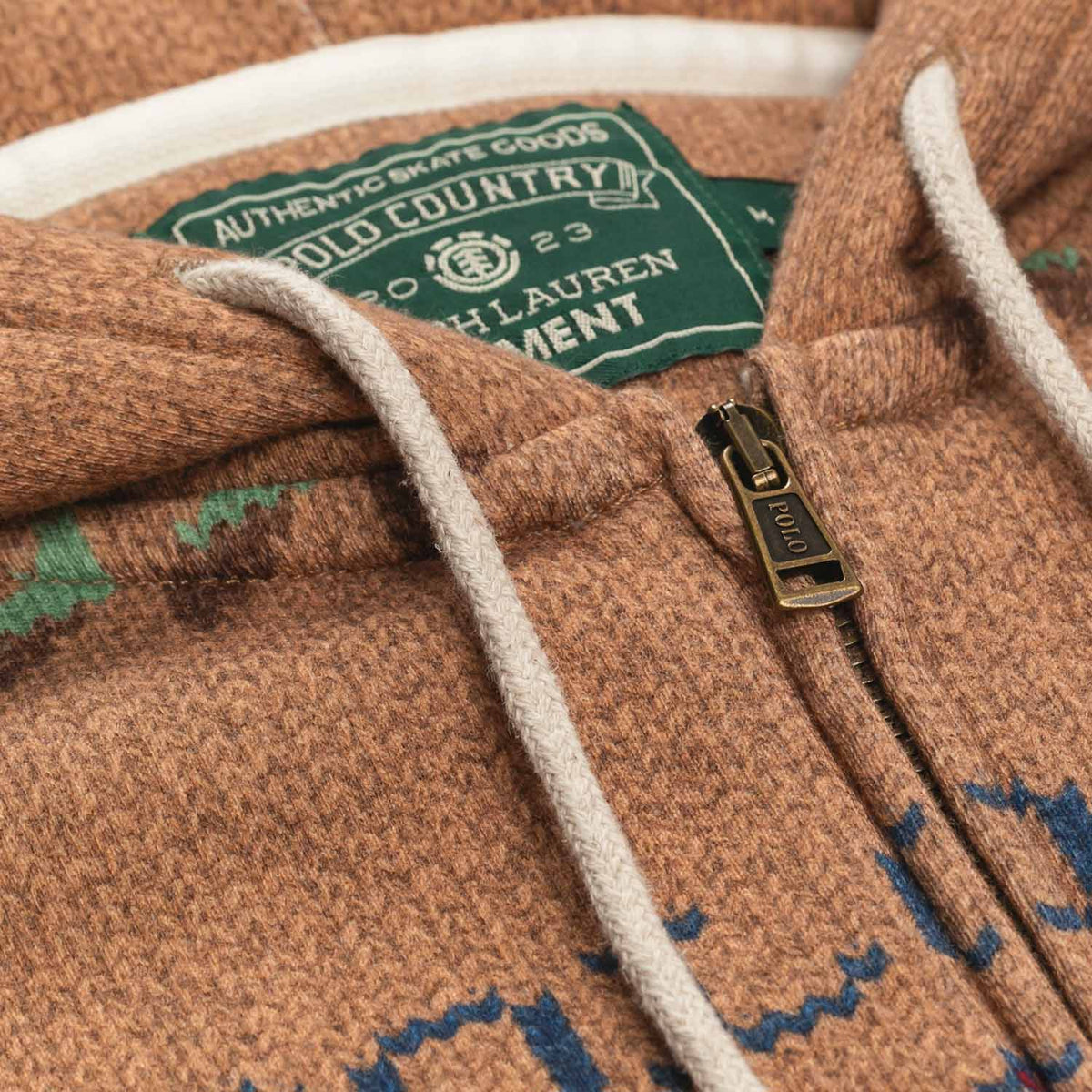 Polo Ralph Lauren x Element Zip up Hoodie in Brown with printed sweater graphic. Warm colors in red, brown, tan, green, and some navy. Close up image of neck of hoodie with green Polo x Element label, and cream colored drawstrings.