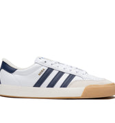 White leather Adias skateboarding shoe with navy leather detailing and cream colored toe cap with white and tan rubber.