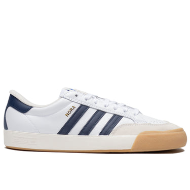 White leather Adias skateboarding shoe with navy leather detailing and cream colored toe cap with white and tan rubber.