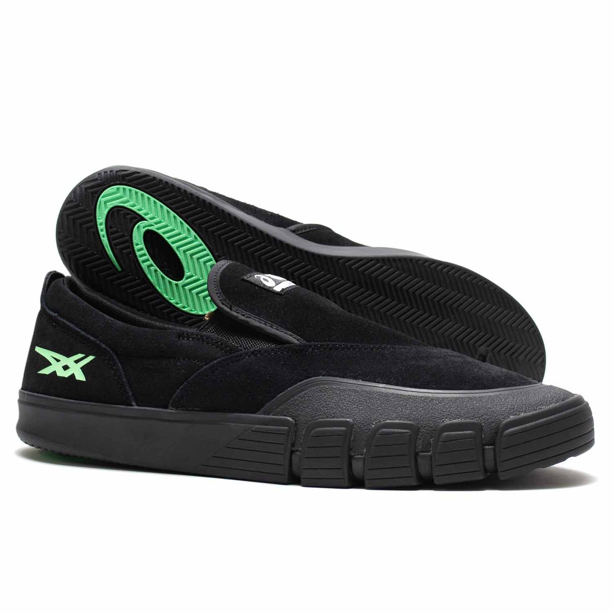 Asics Black slip on shoe with black sole and green asics logo. Chunky outer sole. Suede shoe. Black rubber toe cap.