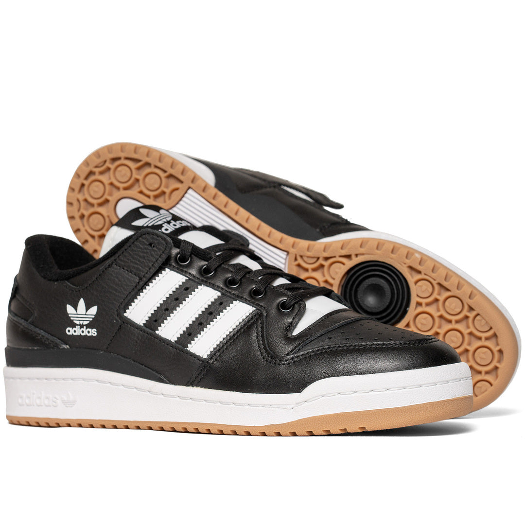 Adidas skateboarding shoe black leather with white stripes, two layered sole with white on top and gum below. Textured gum bottom with white and black details.
