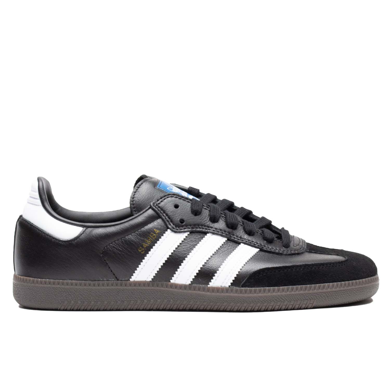 Black leather Adidas skateboarding shoe with white leather stripes and brown rubber sole. Suede toe cap.