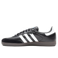 Black leather Adidas skateboarding shoe with white leather stripes and brown rubber sole. Suede toe cap.