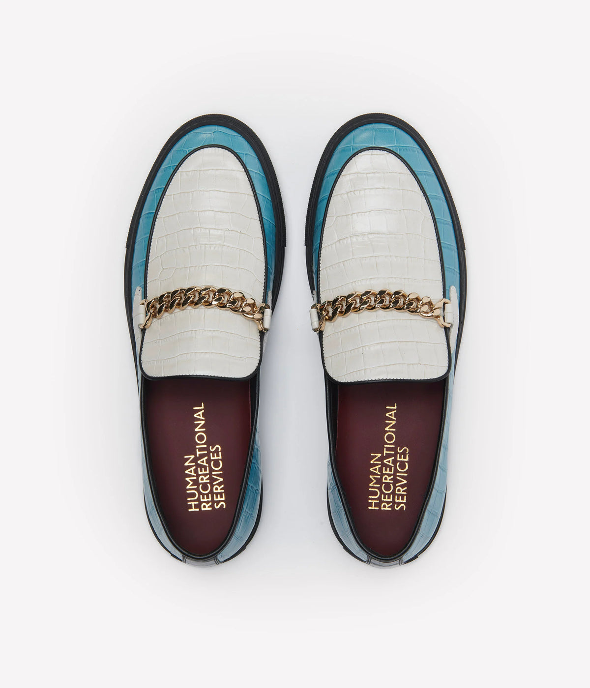 Humean recreational services el dorado loafer made with light blue and white croc leather and gold cuban link chain with black sole. 